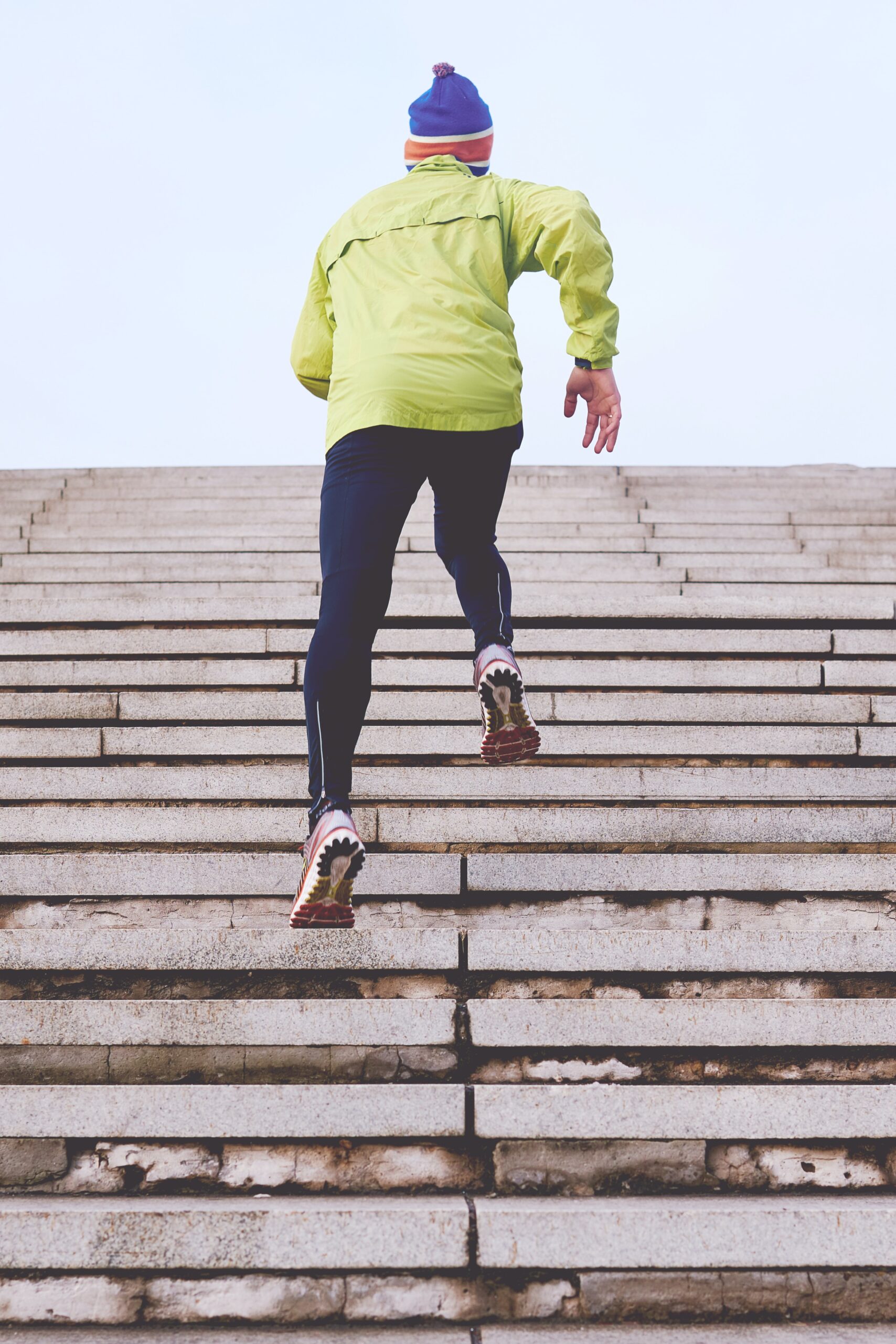 person running up stone stadium stair